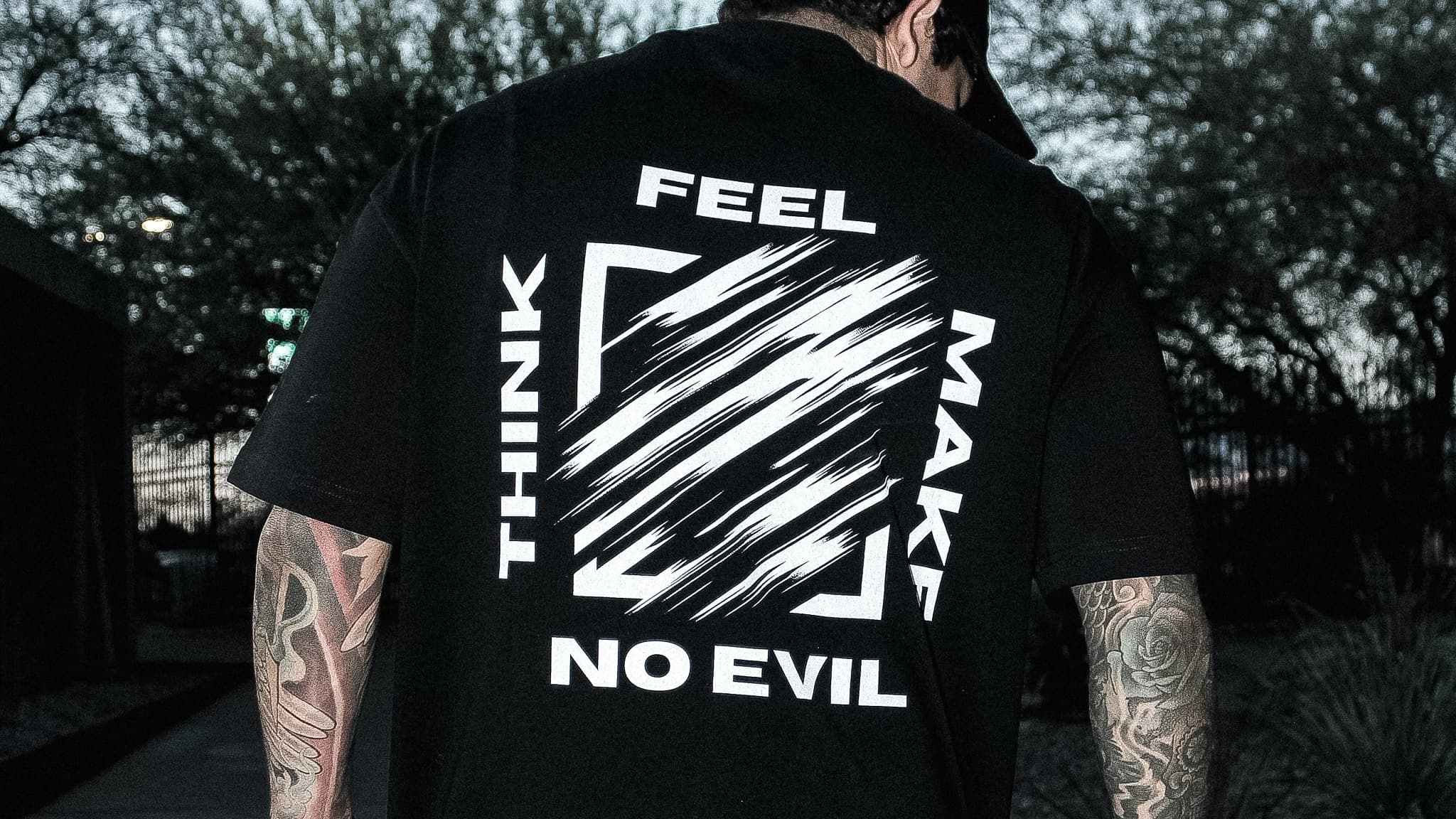 Back view of a No EviL graphic tee with Think, Make, Feel framing
